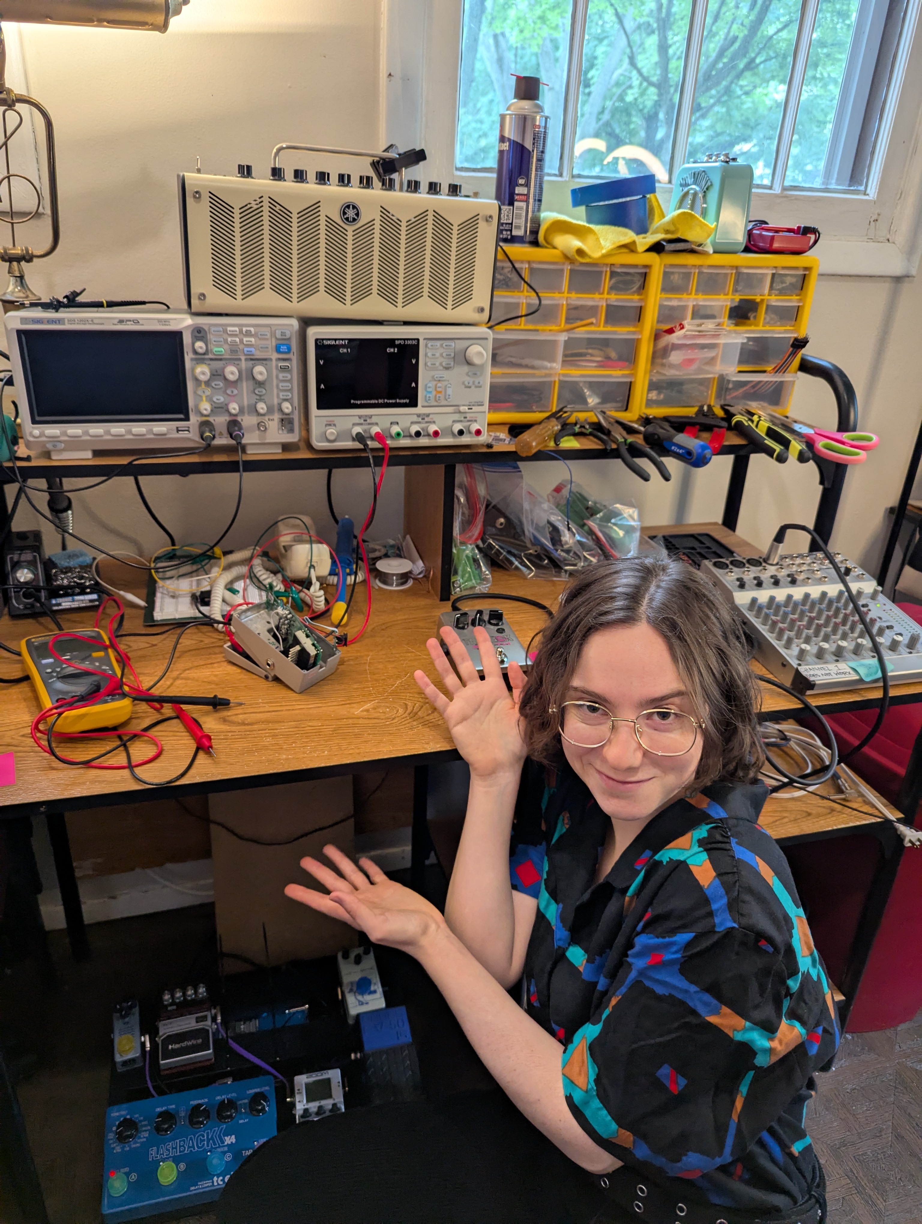 A photo of Dearborn next to an electronics bench, looking mischevious.